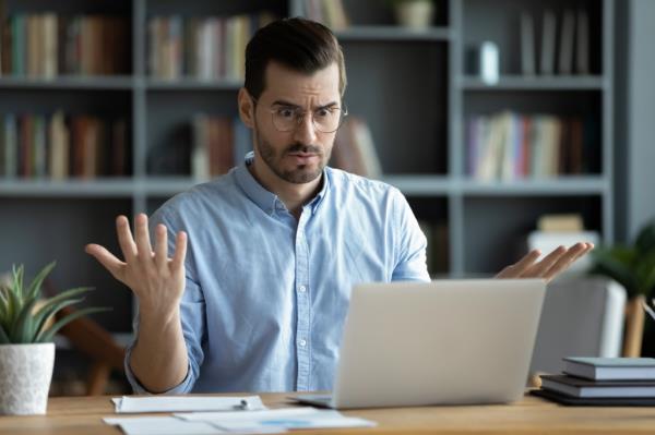 Stock photo of man in front of laptop