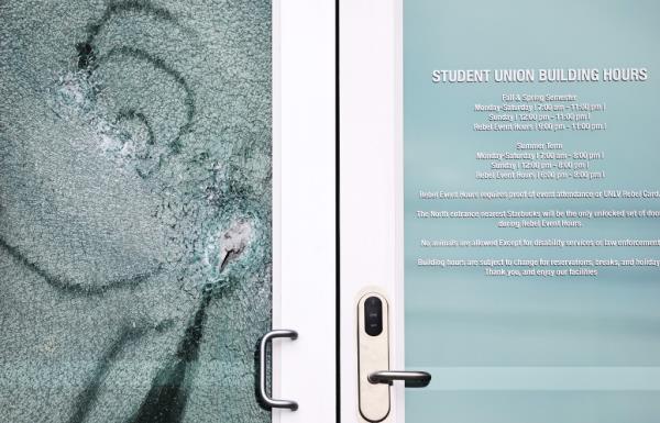  A shattered door is viewed at the student unio<em></em>n building the morning after a shooting left three dead at the University of Nevada.