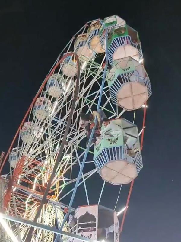 A woman's hair got caught in a Ferris wheeel at a carnival in Dwarka, India.