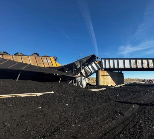 In this photo released by the Pueblo County Sheriff's Office, the wreckage of a train derailment is pictured near Pueblo, Colo., Sunday, Oct. 15, 2023. The train derailment Sunday spewed coal and mangled train cars across the highway. (Joshua Johnson/Pueblo County Sheriff's Office via AP)