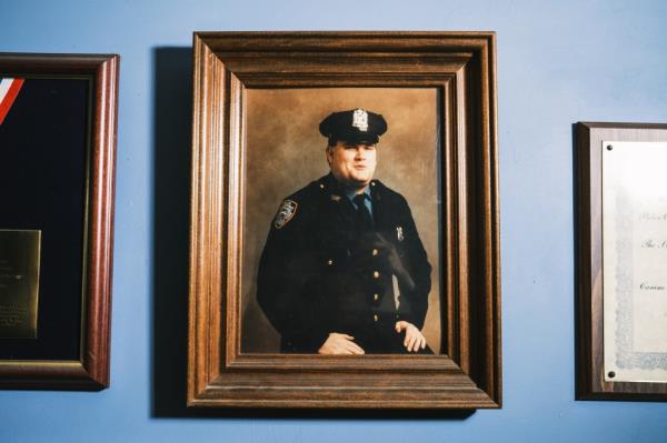 A f<em></em>ramed photo of NYPD officer Anthony Dwyer hangs on the wall of his mother Marge's home.