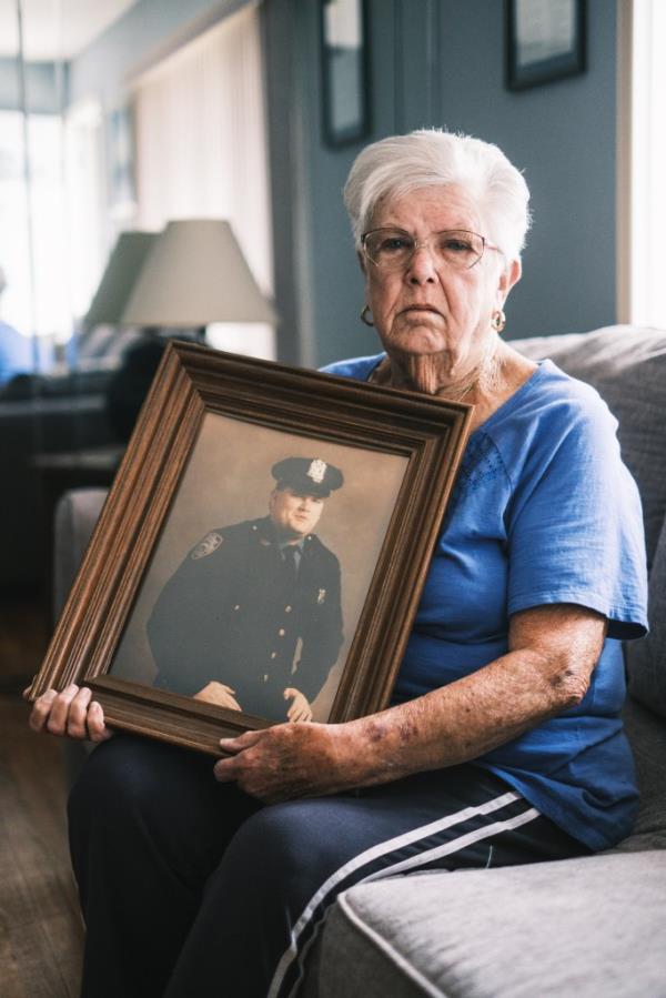 Dwyer's mom, sitting down, holding a picture of her son, NYPD officer Anthony Dwyer