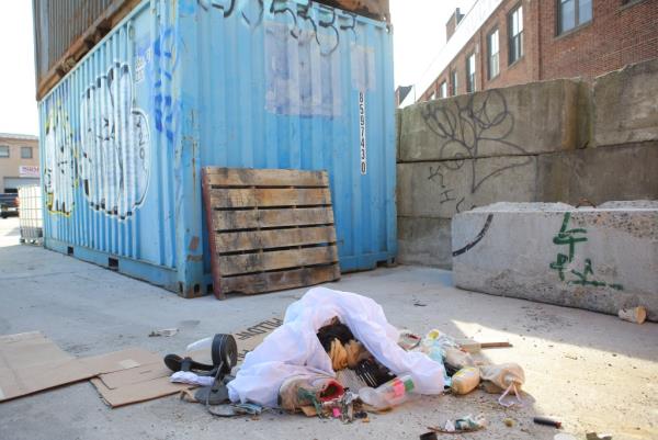 Migrants in a shelter sleeping on the ground amo<em></em>ngst piles of trash with curfew at 11pm – 6am. Manager claims they use co<em></em>ntainers as bathrooms.