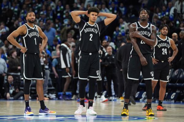 Cam Johnson (center), Mikal Bridgets (left) and Dorian Finney Smith wear frustrated ex<em></em>pressions during the Nets' loss to the Timberwolves. 