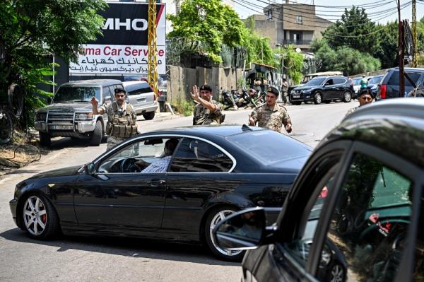 Lebanese army forces turn back motorists as they close a road near the US embassy in Beirut on June 5, 2024, after a Syrian man was arrested following a shooting near the embassy. 