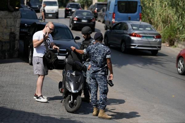 Lebanese soldiers check a driver motorcycle docu<em></em>ment as investigators collect forensic evidence on a road leading to the U.S. Embassy in Aukar, a northern suburb of Beirut, Lebanon, Wednesday, June 5, 2024. 