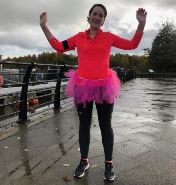 Emma Barker wearing a pink tutu while running a 5k along a canal while raising mo<em></em>ney for Breast Cancer Now as part of their wear it pink day.