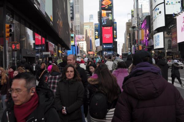 People walking around a snowless NYC this week. 