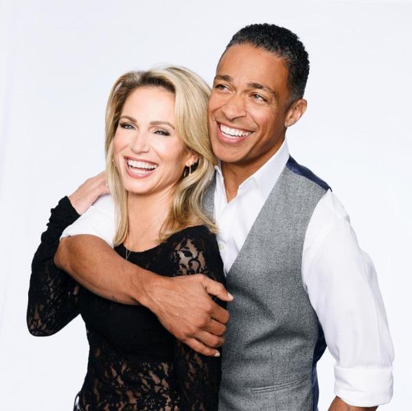 Amy Robach and TJ Holmes smiling and hugging. 