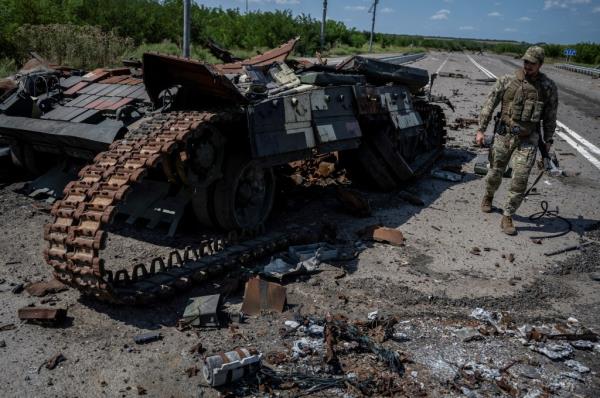 A Ukrainian serviceman walks near a destroyed Ukrainian tank, as Russia's attack on Ukraine continues, near the village of Robotyne, Zaporizhzhia region, Ukraine