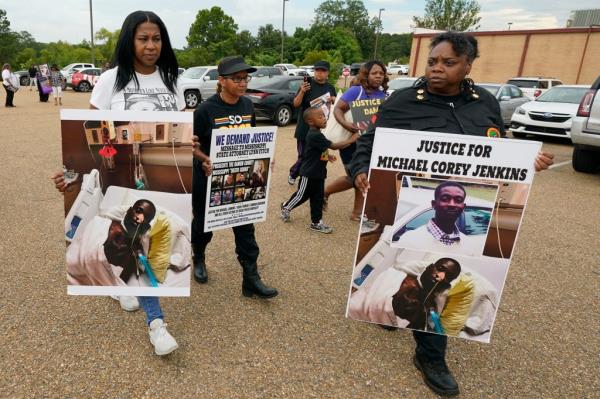 Women holding signs calling for justice for Jenkins