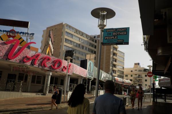 People walk through the street Punta Ballena in Magaluf