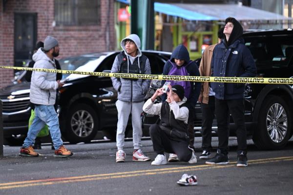 Stunned bystanders look at the scene.