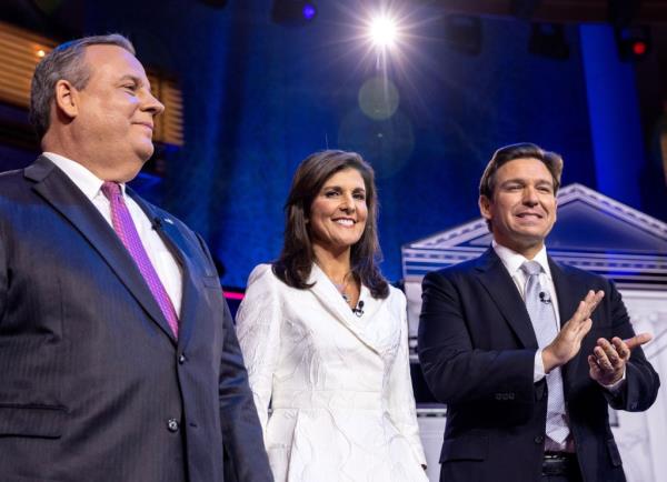 Former New Jersey Governor Chris Christie (L), former South Carolina Governor Nikki Haley (C) and Florida Governor Ron DeSantis (R) pose on stage prior to the GOP NBC News Republican Presidential Debate at the Adrienne Arsht Center for the Performing Arts of Miami-Dade County in Miami, Florida.