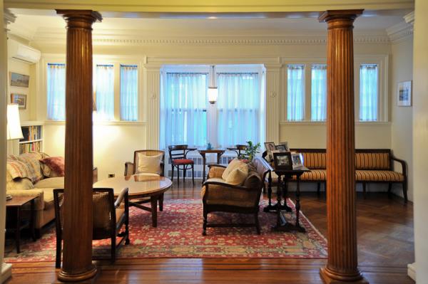 Den area inside Janno Lieber's Victorian Flatbush home in Brooklyn, featuring tables and couches