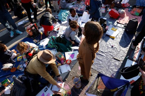 Palestinian children participating in a 'Rage Play Date' protest near Senator Chuck Schumer's Brooklyn residence, colouring and writing letters in support of Palestine.