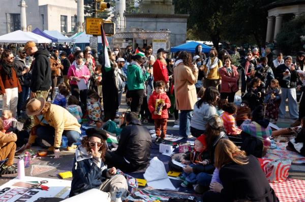 children participating in 'Rage Play Date' protest outside Majority Leader of the US Senate Chuck Schumer's home in Brooklyn, with police in the area