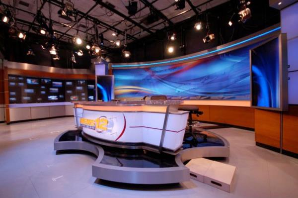 A news studio with a large screen for News 12 Long Island