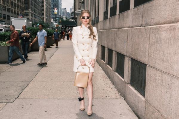 Anna Delvey in a white dress and her ankle bracelet.