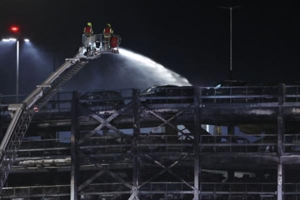 A charred section of a parking structure is seen after it caught fire and partially collapsed at London's Luton Airport on October 11, 2023. 