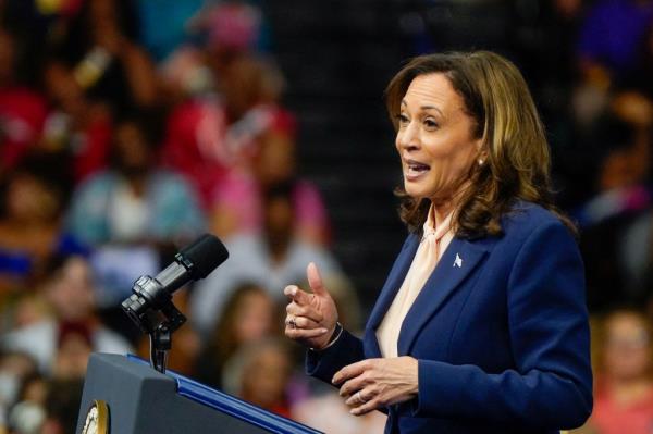 Vice President Kamala Harris delivering a speech at a campaign rally in Philadelphia, with VP candidate Tim Walz