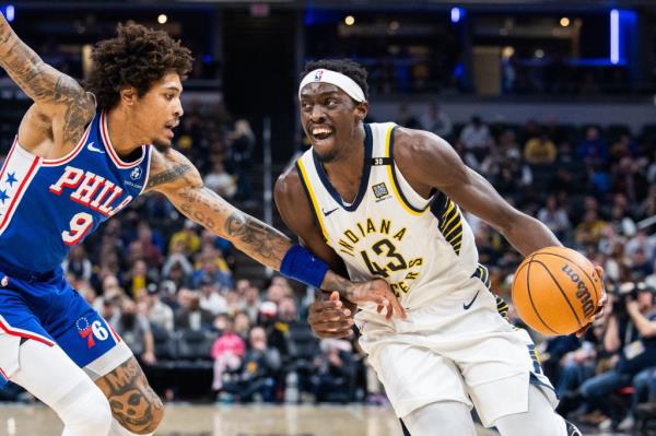 Indiana Pacers' Pascal Siakam dribbles the ball as Philadelphia 76ers' Kelly Oubre Jr. defends during an NBA game at Gainbridge Fieldhouse.