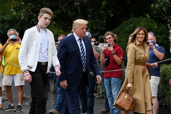 Barron Trump is seen walking with his father and mother Melania