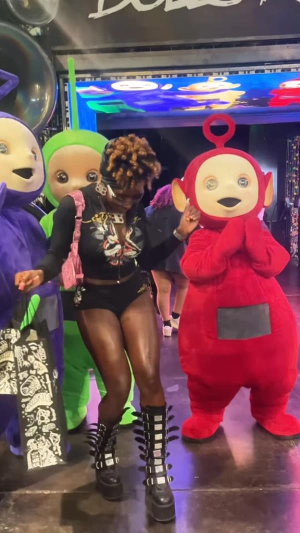 Teletubbies partying with adult fans. 