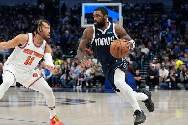 Kyrie Irving, who had 44 points and 10 assists, drives on Jalen Brunson during the Knicks' 128-124 loss to the Mavericks.