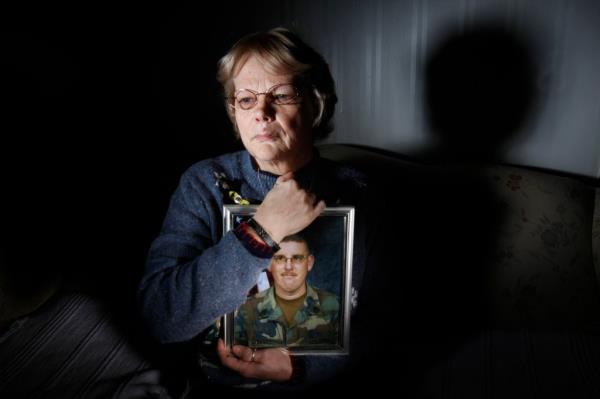 Kathleen Berry holds a portrait of her husband, David, who was killed in Iraq.