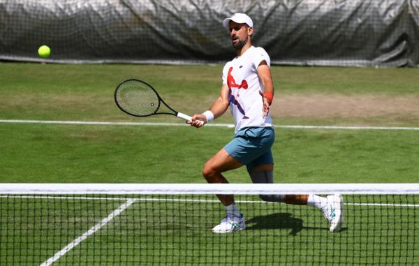 Novak Djokovic hits a forehand volley during a practice session at the All England Lawn Tennis and Croquet Club in preparation for Wimbledon which begins on Monday.