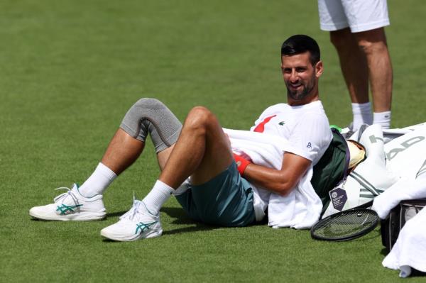 A smiling Novak Djokovic takes a break during during a practice session at the All England Lawn Tennis and Croquet Club in preparation for Wimbledon which begins on Monday.