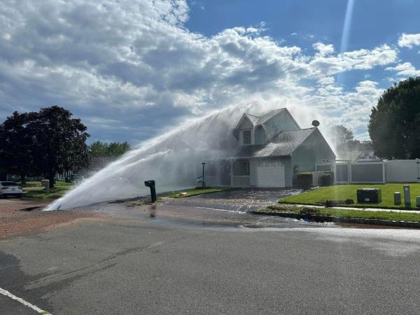 The water main break sending water toward the house. 