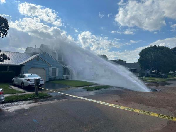 The water main break sending water toward the house. 