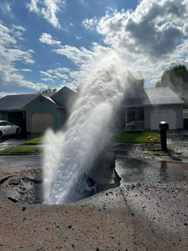 The water main break sending water toward the house. 