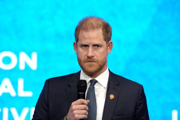 Prince Harry, Duke of Sussex, in a suit holding a microphone at the Clinton Global Initiative 2024 Meeting in New York, USA.