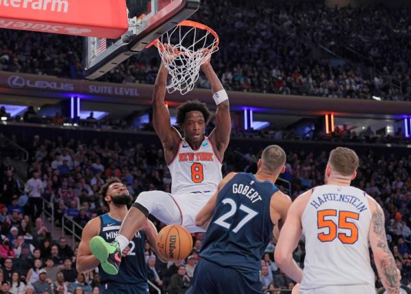 Knicks forward OG Anunoby #8 slams the ball over Minnesota Timberwolves center Rudy Gobert #27 during the second quarter.