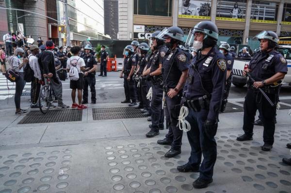 Police officers co<em></em>nfronting protesters on 42nd street in New York during a demo<em></em>nstration against the death of George Floyd