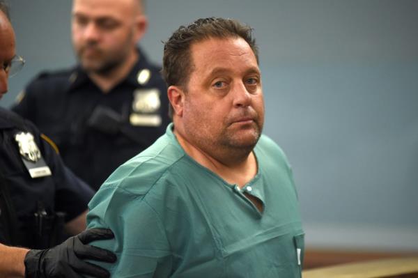 Daniel Coppola, 50,  Arraigned for double murder For killing his ex wife and her lover.  He was dressed in green hospital scrubs with socks and no shoes as he was loaded into a waiting police vehicle for his arraignment in Central Islip.