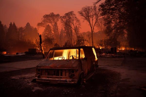 FILE - Flames burn inside a van as the Camp Fire tears through Paradise, Calif., on Thursday, Nov. 8, 2018. Currently, the Maui wildfires are the nation's fifth-deadliest on record, according to research by the Natio<em></em>nal Fire Protection Association, a no<em></em>nprofit that publishes fire codes and standards used in the U.S. and around the world.  The Camp Fire killed 85 people and forced tens of thousands of others to flee their homes as flames destroyed 19,000 buildings in Northern California.  